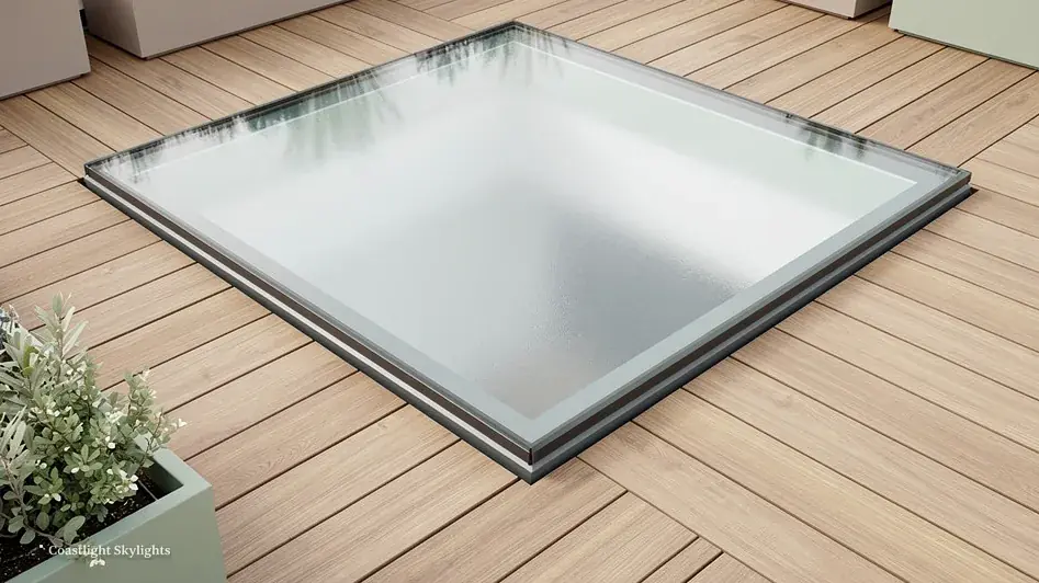 Square walk-on glass panel set flush into timber decking