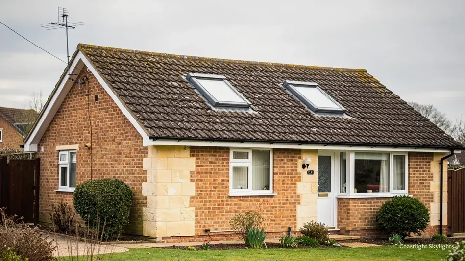 Brick bungalow with two roof windows set into its tiled roof