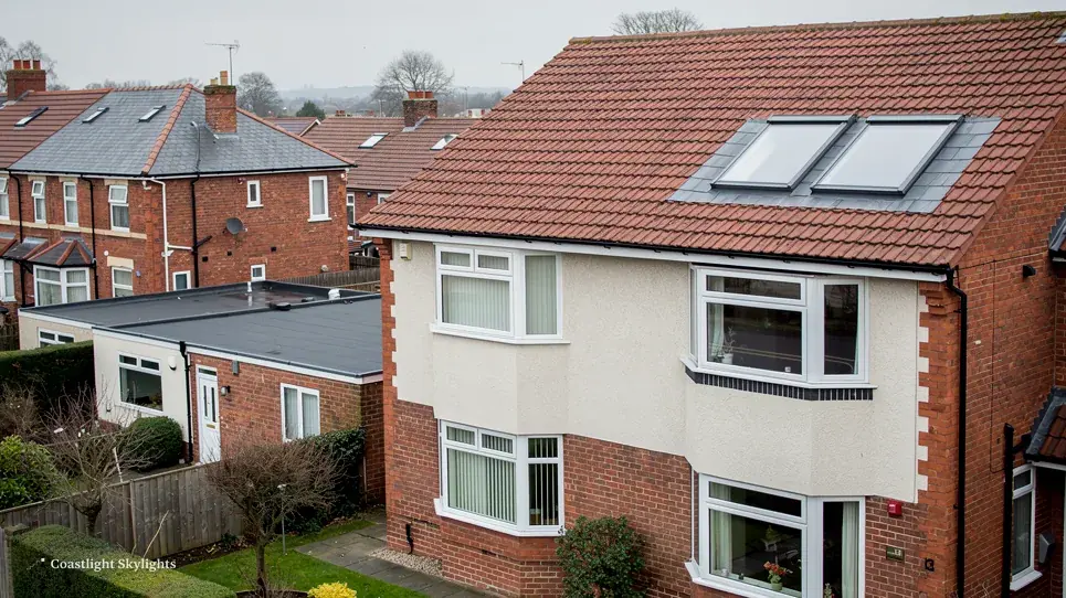 Semi-detached house with two roof windows set into a red tiled loft conversion roof