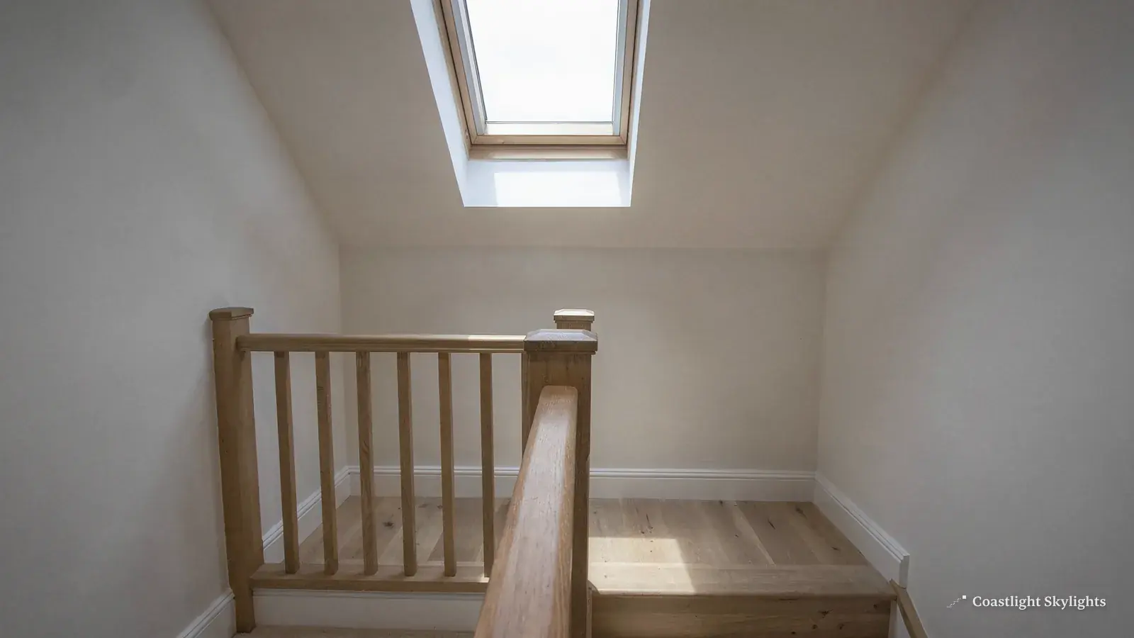 Landing with a timber balustrade and a roof window in the ceiling above