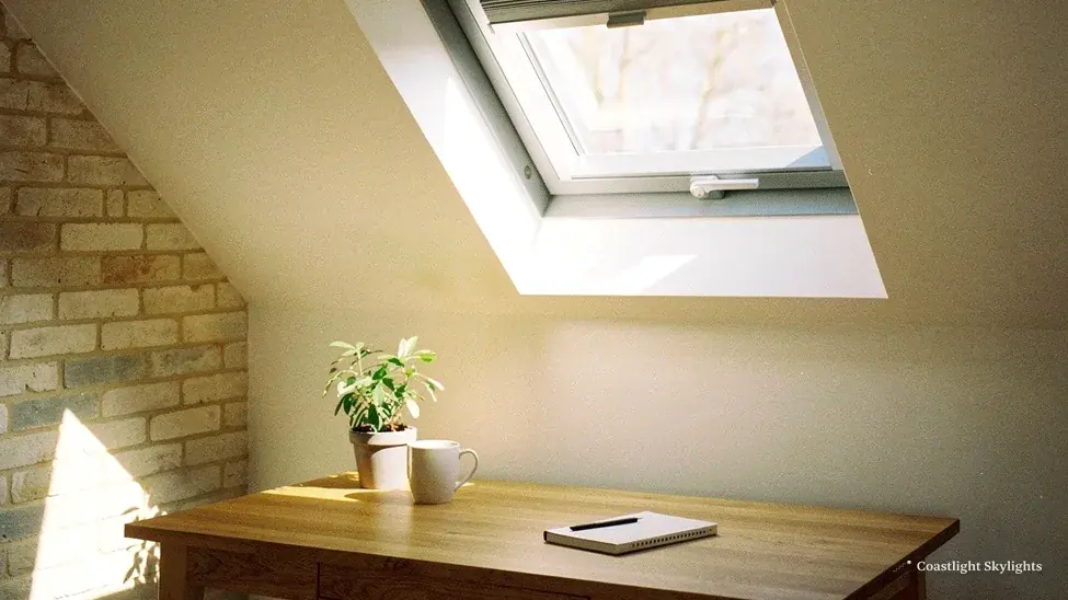 Roof window seen from inside beside a yellow brick wall