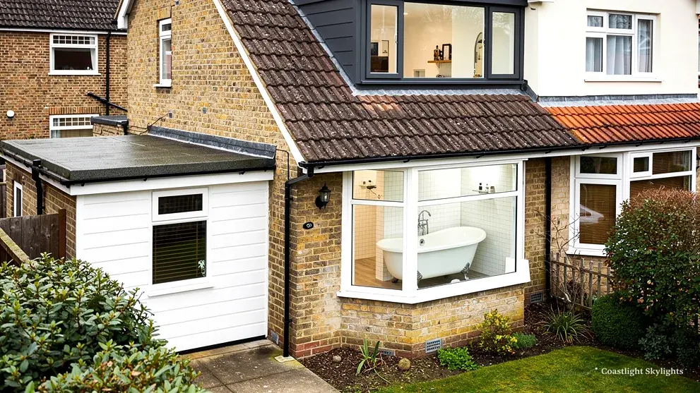 Brick house with a dormer, a flat roofed extension and a glazed side window