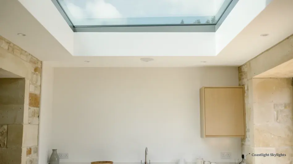 Room with a stone wall and a rooflight in the ceiling above