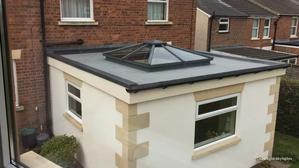Glass pyramid roof lantern on the flat roof of a rendered rear extension