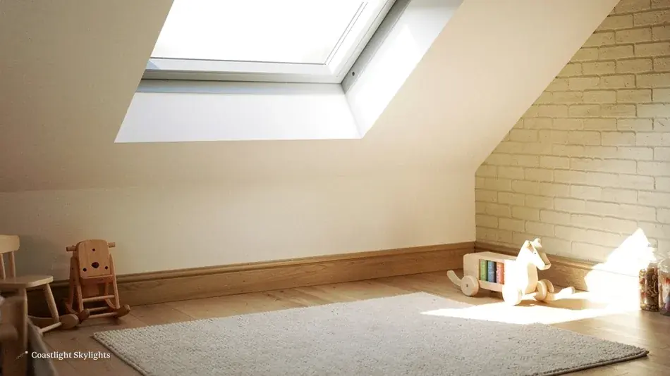 Empty loft room with oak floor, a stone wall and a roof window above
