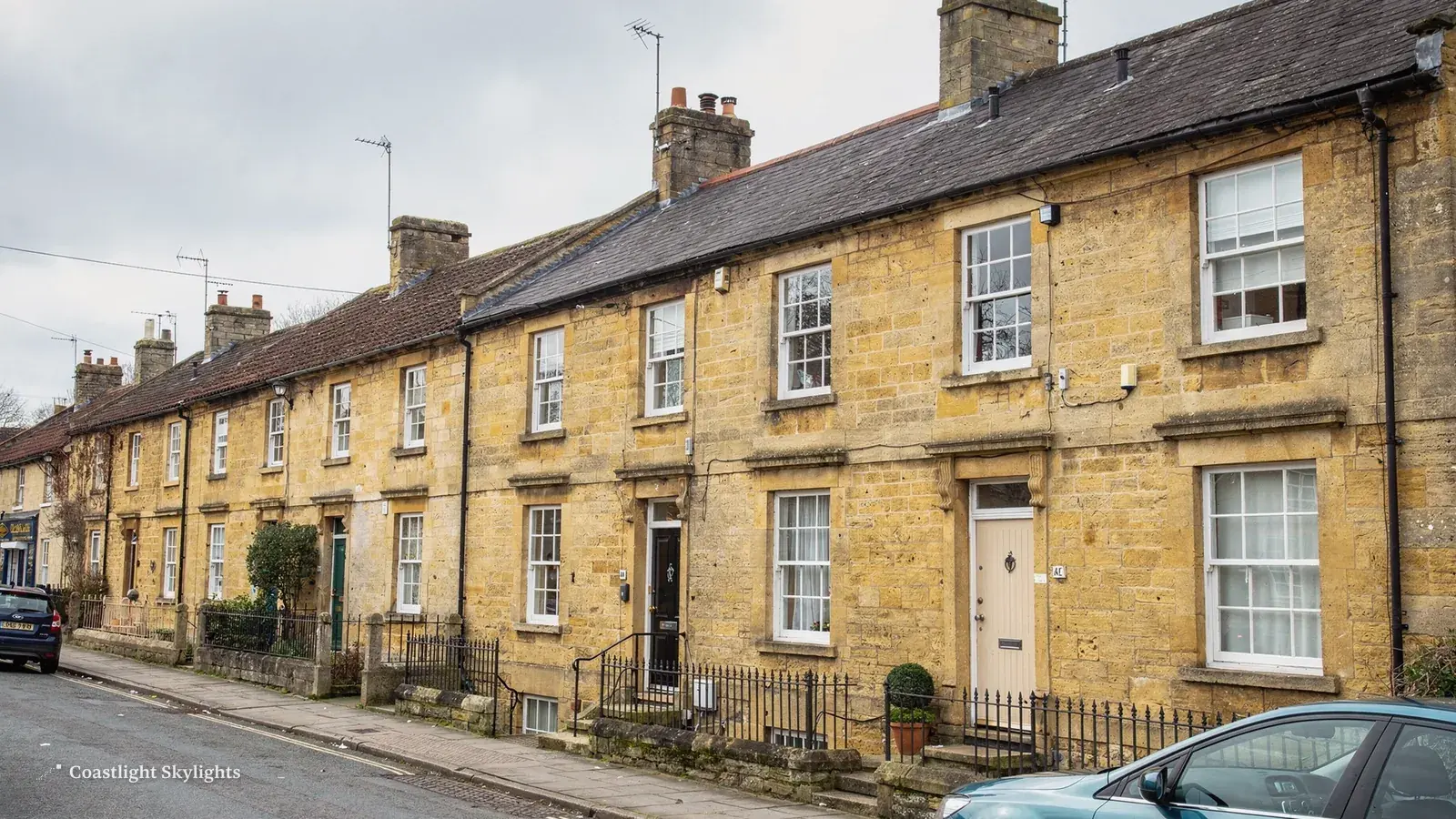 Street of yellow brick terraced cottages with pitched roofs