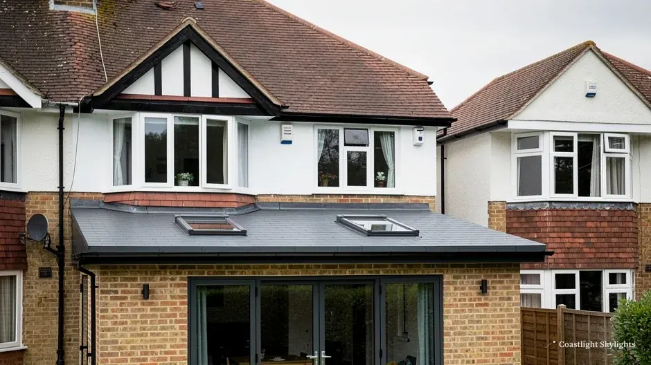 Semi-detached house with a flat roof extension, a glass lantern and folding doors